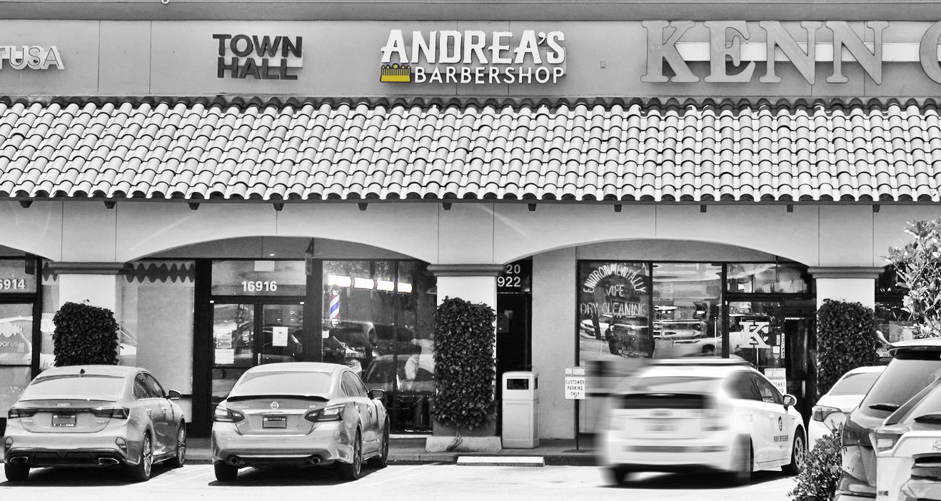 Andrea's Barbershop and large parking lot'