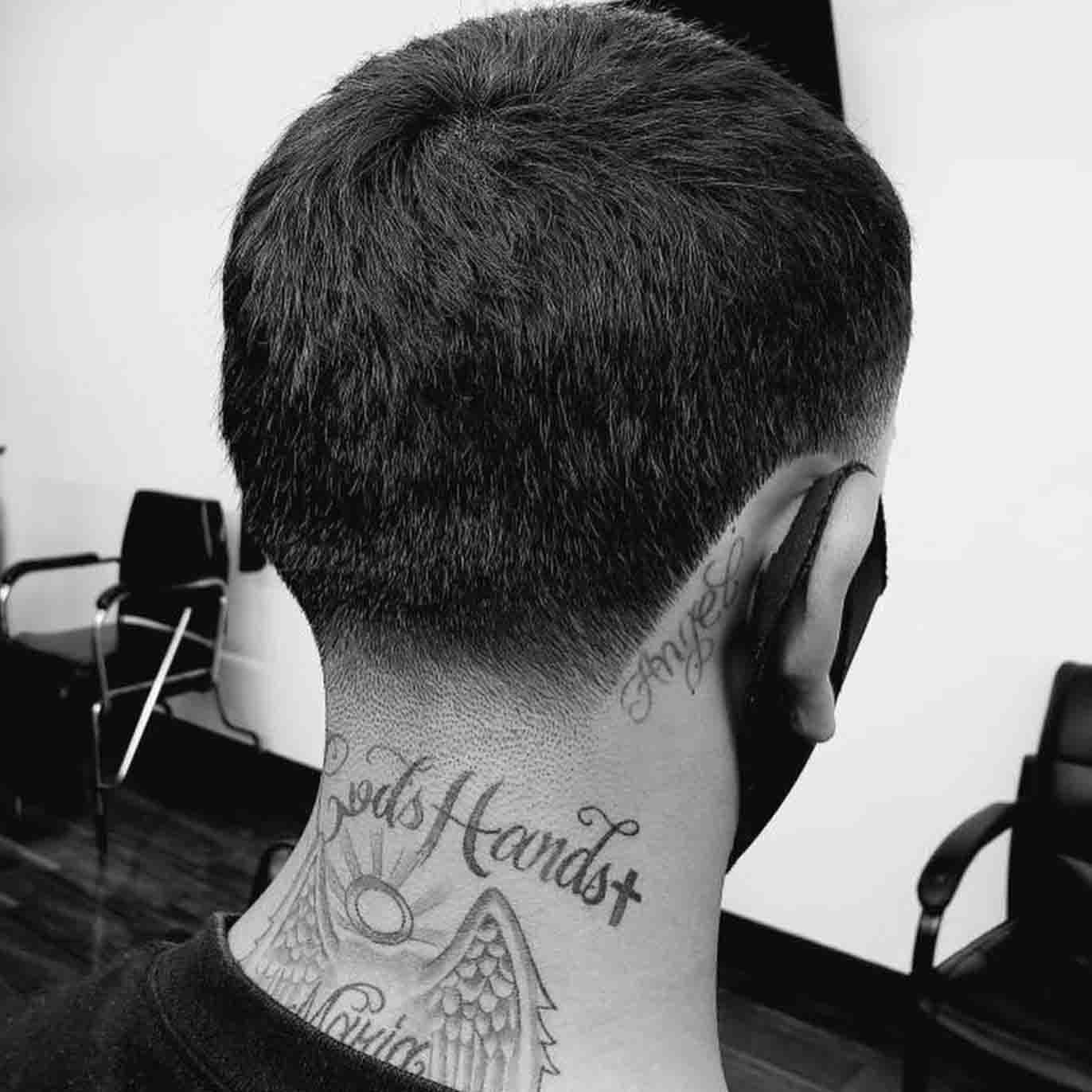 Haircut showcasing neck tattoos